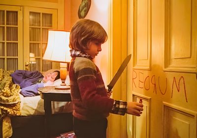 a young boy holding a large knife in his hand and writing on the wall behind him The Shining Laptop Halloween The Shining, The Shining Here Comes Johnny, Classic Horror, chocolate