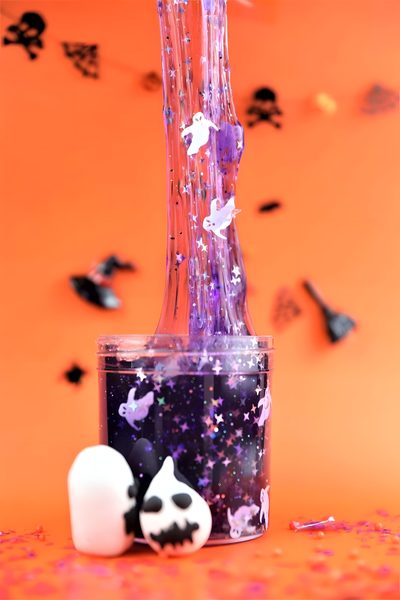 two halloween decorations in a glass vase with purple and white sprinkles on an orange background Halloween Slime Hd Slime Halloween, Lava Lamp, Slime, Novelty Lamp, Table Lamp, Halloween, coral