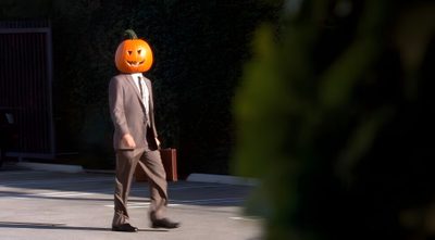 a man in a suit and pumpkin mask walks down the street Funny Halloween Computer Dwight Pumpkin Head, The Office Halloween Episodes, The Office Spotify Covers, black