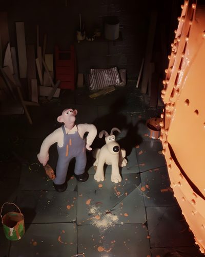 two stuffed animals sitting next to each other on a floor in front of a wall Wallace And Gromit Halloween Background Wallace And Gromit Happy Birthday, Wallace And Gromit Cat, Wallace And Gromit, black