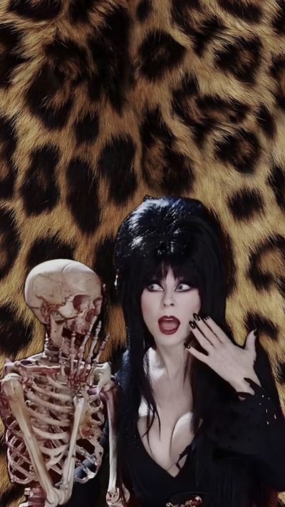 a woman dressed as a skeleton with her hands up to her face, standing in front of a leopard print background Elvira Halloween Gothic Pictures, Cassandra Peterson, Elvira Mistress Of The Dark, Scary, dark slate gray