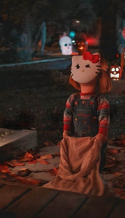 a hello kitty doll is standing on the ground in front of some pumpkins at night Halloween Chucky Chucky Halloween, Chucky Movies, Halloween Backgrounds, Scary Movie Characters, black