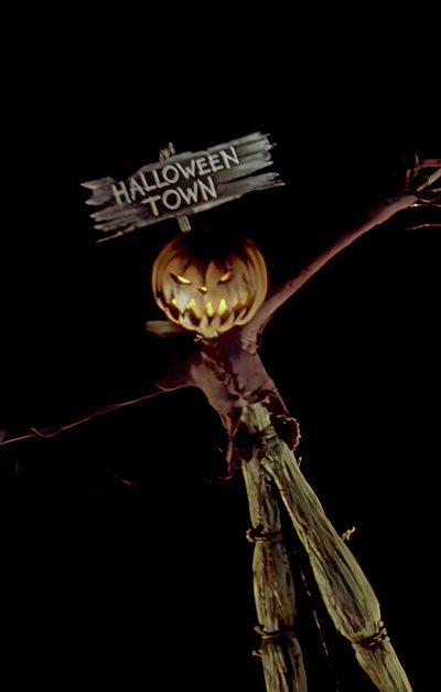 a scarecrow holding a sign that says halloween town Halloween Town Movie This Is Halloween, Halloween Movie Lockscreen, Halloween Aesthetic Nightmare Before Christmas, black