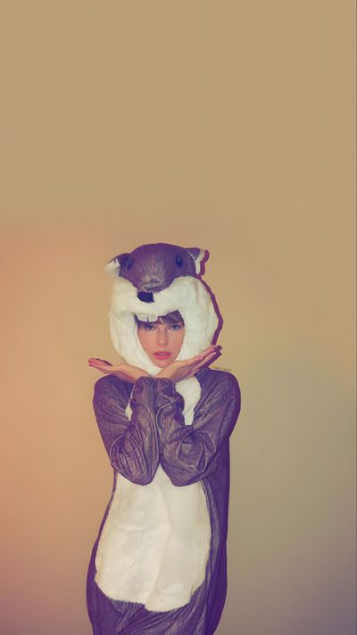 a woman wearing a costume with an animal on her head and hands in front of her face Taylor Swift Halloween Taylor Swift Halloween Aesthetic, Taylor Swift Thanksgiving, Halloween Taylor Swift, rosy brown