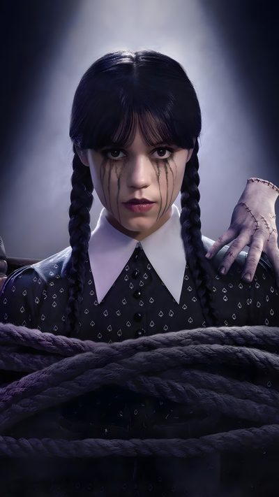 a woman with long braids in her hair and wearing a black shirt, standing next to a rope Wednesday Addams Halloween Uncle Fester, Madame Doubtfire, Riki Lindhome, The Addams Family, black