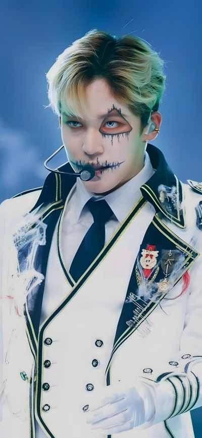 a man with makeup on his face wearing a white suit and black bow tie, holding something in his hand Ateez Halloween Ateez Demon Line, Kpop Demon Hunter Makeup, Wooyoung Halloween Ateez, dark gray