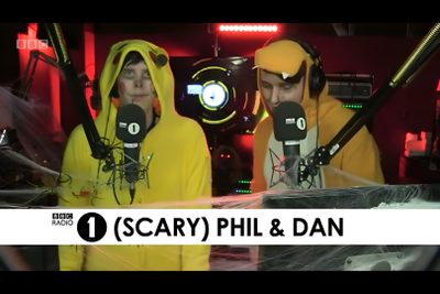 two people in yellow costumes standing next to each other with microphones on their heads Dan And Phil Halloween 2009 Dan And Phil Halloween Baking, Dan Howell Halloween Costume, Dan And Phil Bbc Radio 1, dark slate gray