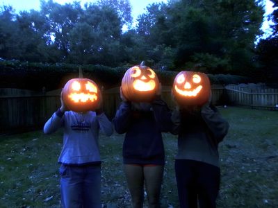 three people holding pumpkins with faces carved into them 2000s Halloween Aesthetic Catty Noir, Halloween Pictures With Friends, Friend Pumpkin Head Photoshoot, dark slate gray