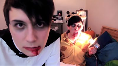 two people dressed up in costumes and one has blood on his face while the other holds a cell phone Dan And Phil Halloween 2009 Frank Horrigan Gif, Dan And Phil Nun Costume, Phil Lester Halloween, indian red
