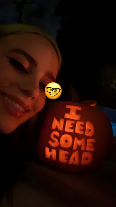 a woman holding up a pumpkin with the words i need some head carved on it Billie Eilish Halloween Billie Eilish Pumpkin Painting, Billie Eilish Pumpkin Carving Ideas, Billie Eilish Pumpkin, black