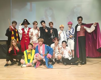 a group of young men standing on top of a wooden floor next to each other Seventeen Halloween Seungkwan Halloween, Seventeen Halloween, Seventeen Costume Ideas, dark gray