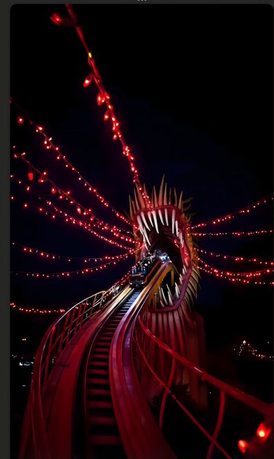 the train is going down the tracks in the night time scene with red lights on it Halloween Roller Coaster New York New York Roller Coaster At Night, Roller Coaster, Roller Coaster Iphone, black