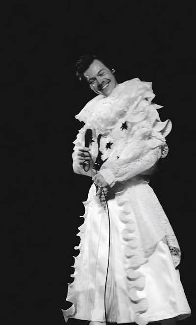 a woman in a white dress is holding a microphone Harry Styles Happy Halloween Iphone Harry Styles Lockscreen Subtle, Harryween, Harry Styles Halloween, black