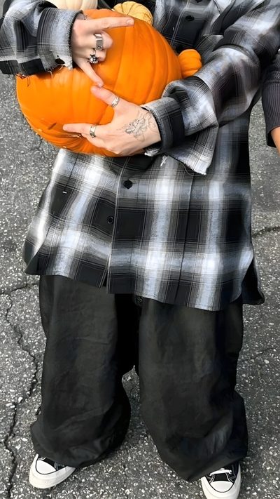 a man holding a pumpkin in his hands Billie Eilish Halloween Billie Eilish Fall, Billie Eilish Fall Aesthetic, Billie Eilish Halloween Costume 2023, dark olive green